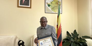 Zimbabwe ambassador to China, Ambassador Martin Chedondo displays Professor Lingyun Xiang’s letter of appointment at the Embassy of Zimbabwe in Beijing. Credit: Globenewsire