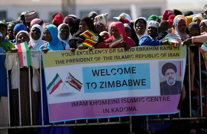Supporters of Iran's President Ebrahim Raisi welcome him upon his arrival at Robert Mugabe airport in Harare, Zimbabwe, Thursday, July 13, 2023. Iran's president is on a rare visit to Africa as the country, which is under heavy U.S. economic sanctions, seeks to deepen partnerships around the world. (AP Photo/Tsvangirayi Mukwazhi)ASSOCIATED PRESS